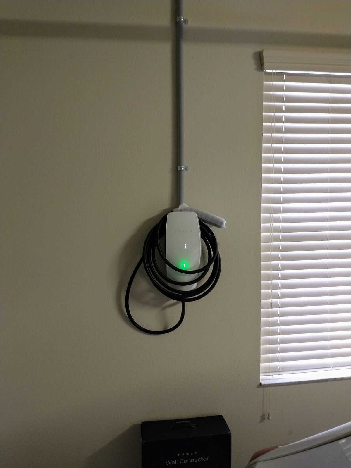 A home EV wall charger installed in a residential garage