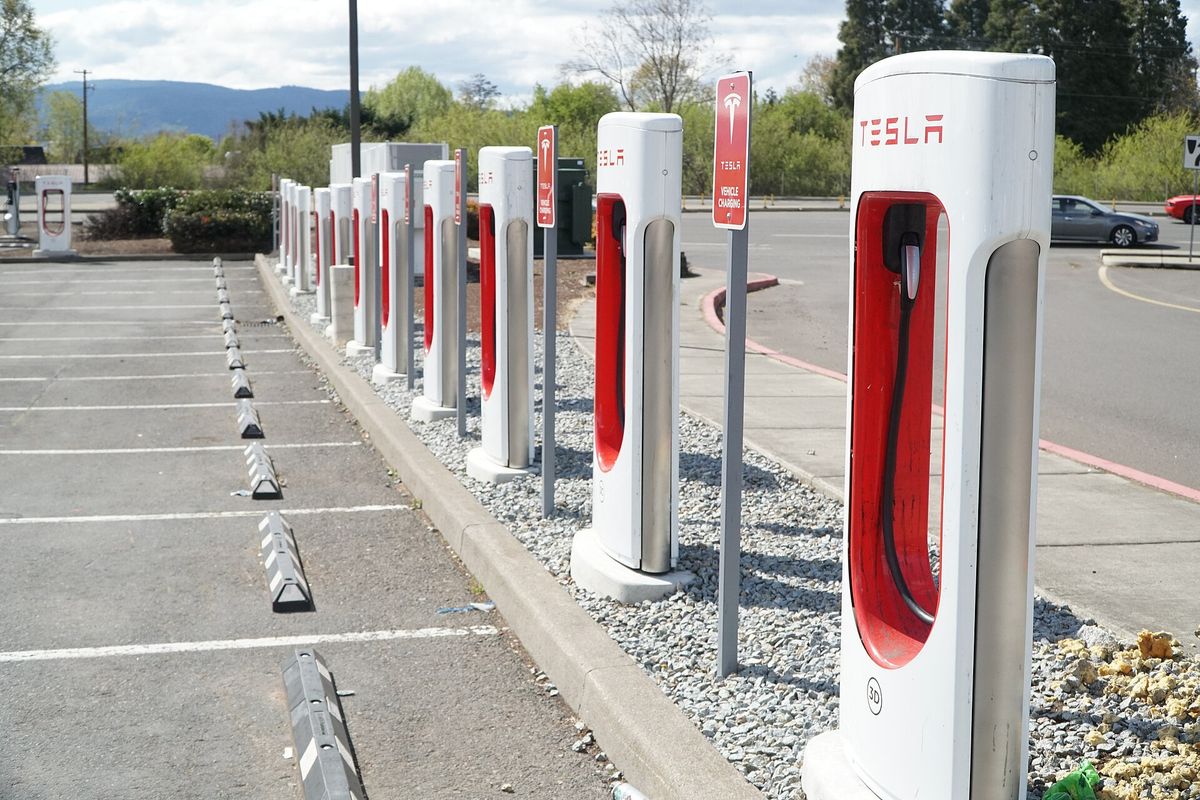 Row of Tesla EV charging stations in an outdoor parking lot