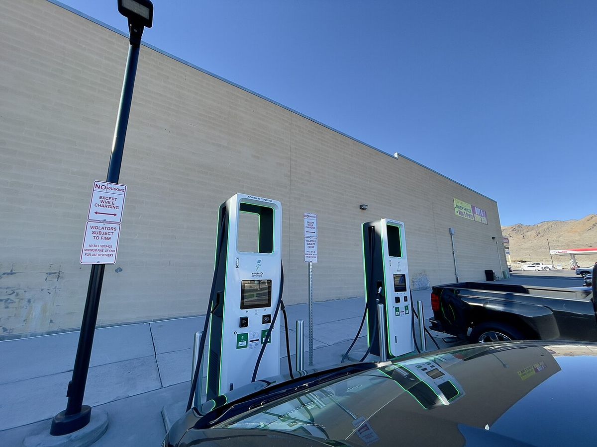 Home Level 2 EV charging station plugged into an electric car