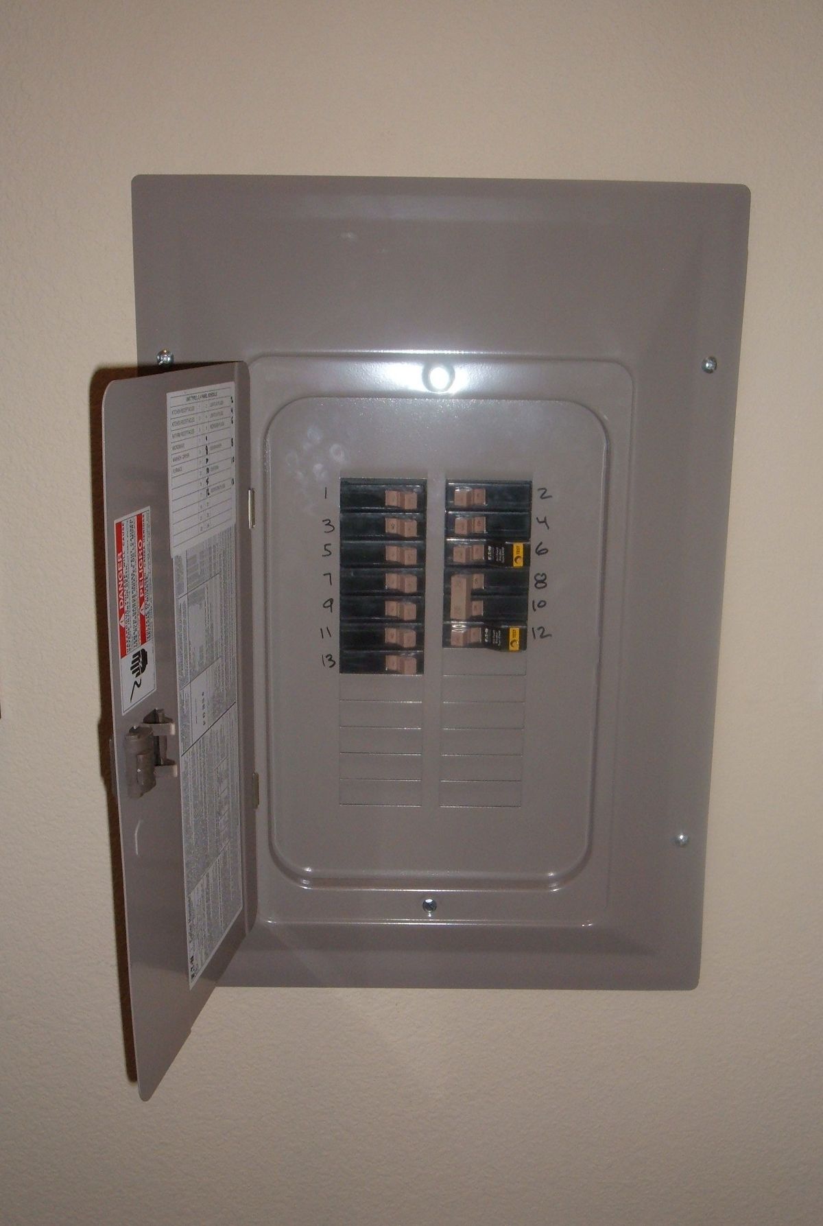 Open residential circuit breaker panel with labeled breakers