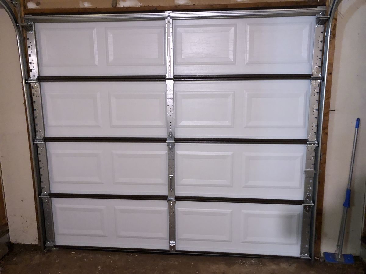 Interior side of a metal garage door inside a home garage