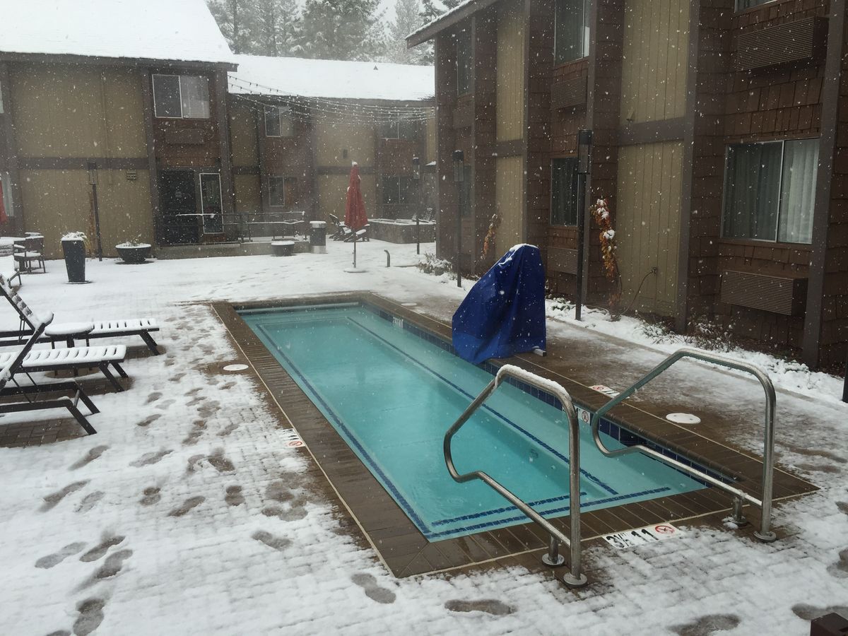 Heated outdoor pool steaming during a snowstorm