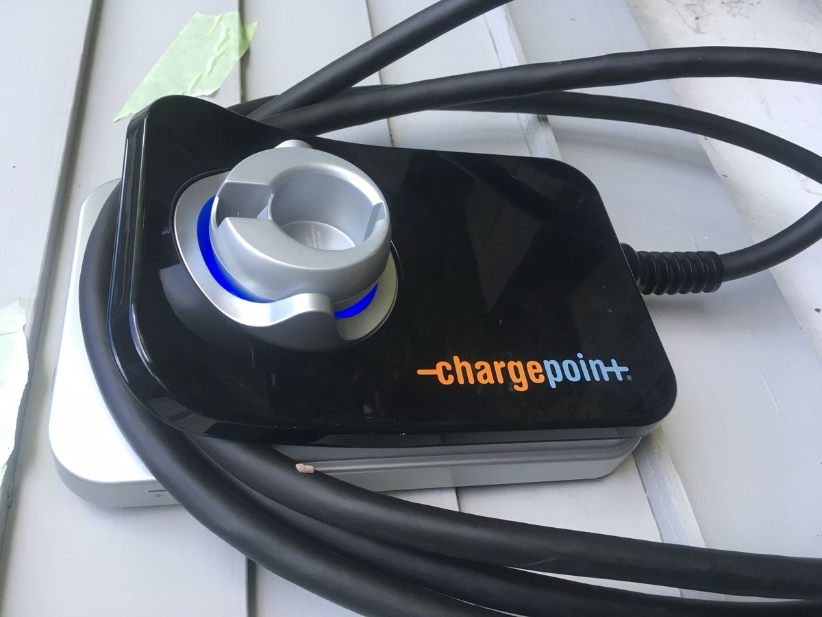 Close-up of a ChargePoint home EV charger with coiled cable