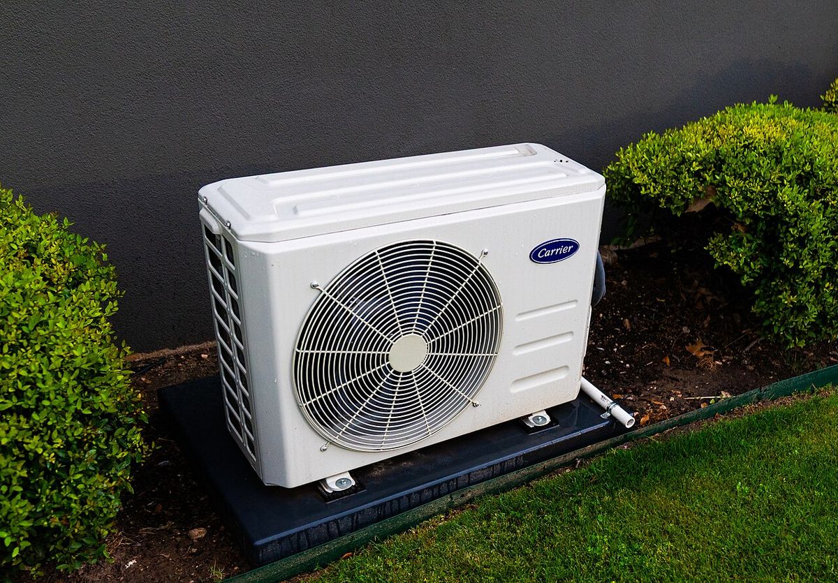 Outdoor heat pump unit in winter snow