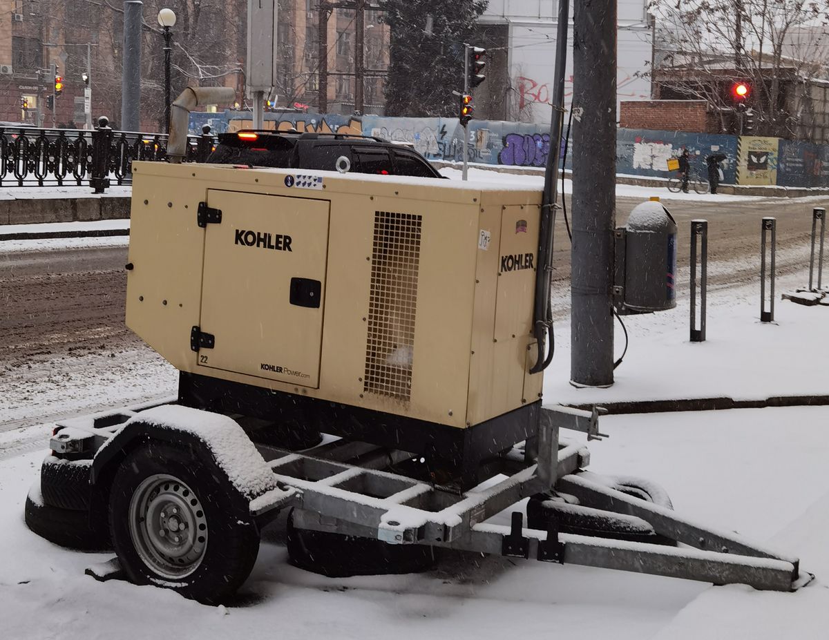 Kohler generator unit on a trailer parked on a snowy street