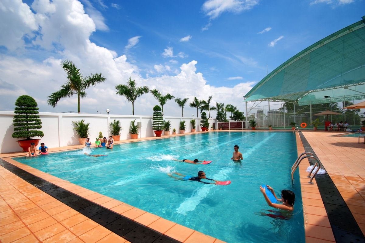 Swimmers in a clear blue swimming pool