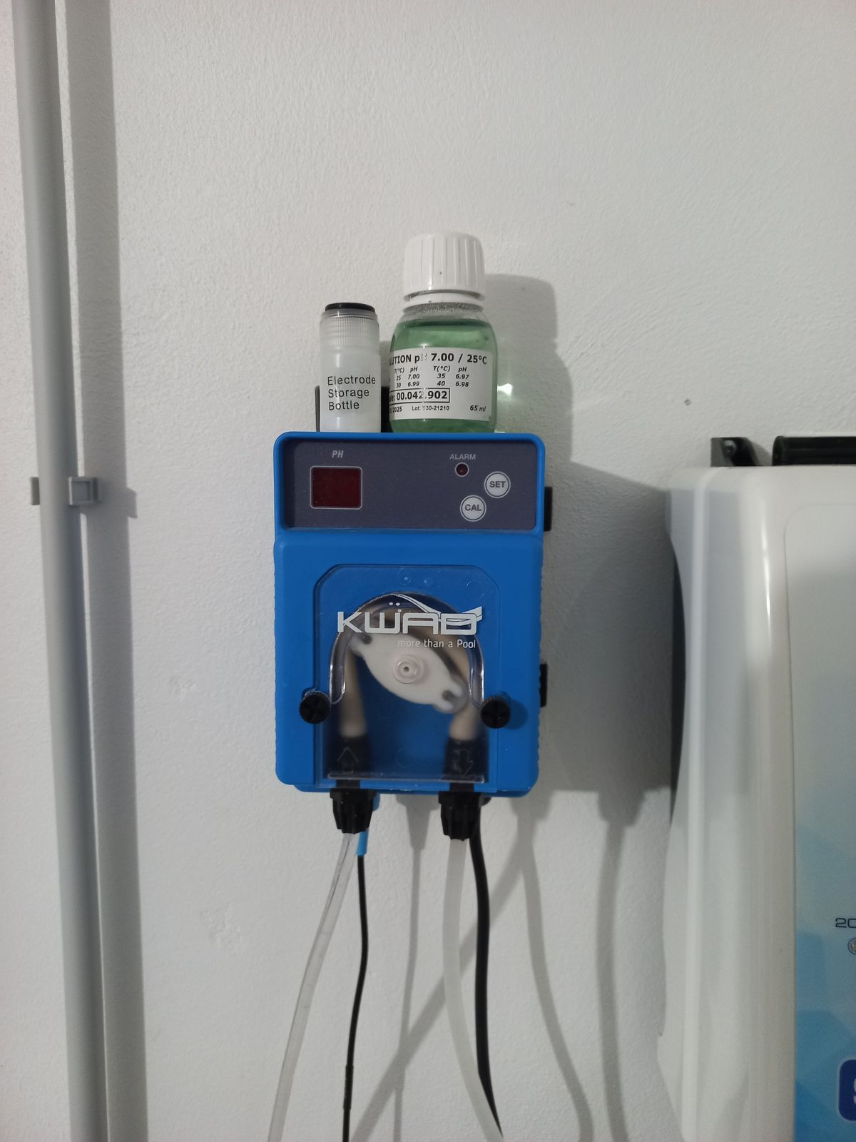 Salt chlorine dosing pump mounted on a pool equipment wall