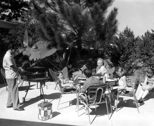 Family enjoying a backyard barbecue on the patio