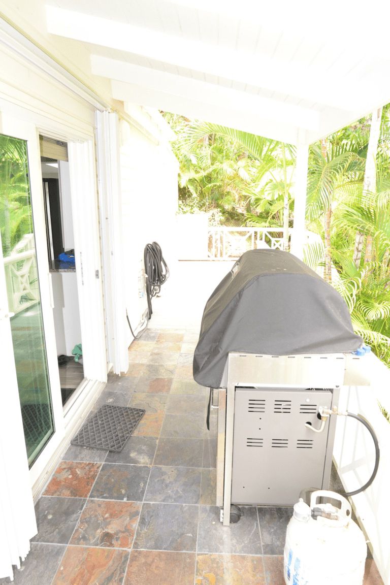 Grill with protective cover on a patio