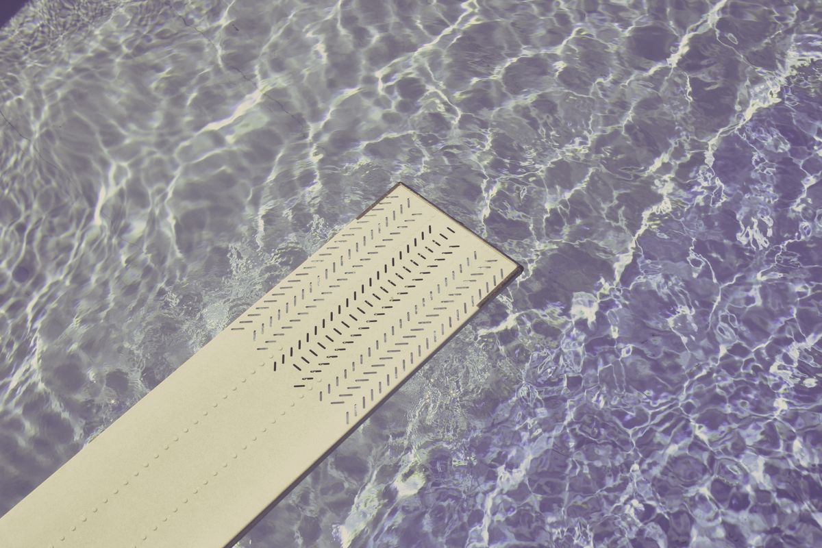 A diving board extending over a swimming pool