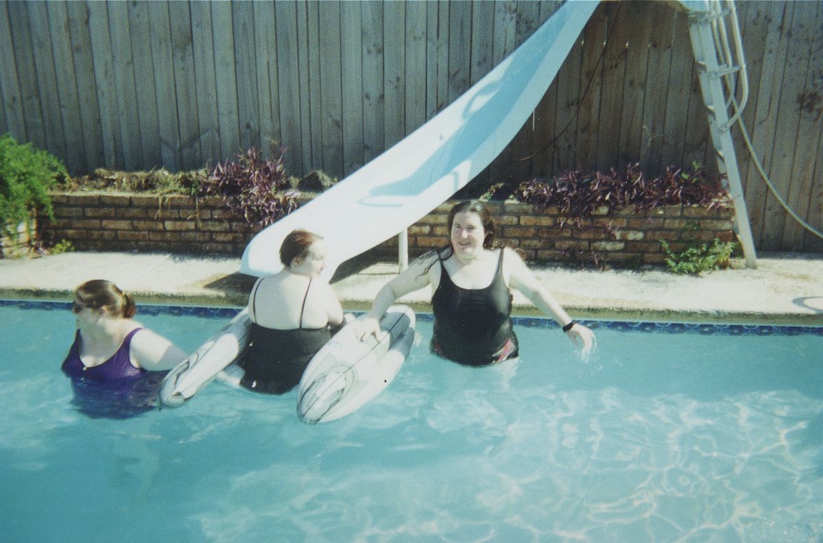 A backyard swimming pool with a water slide