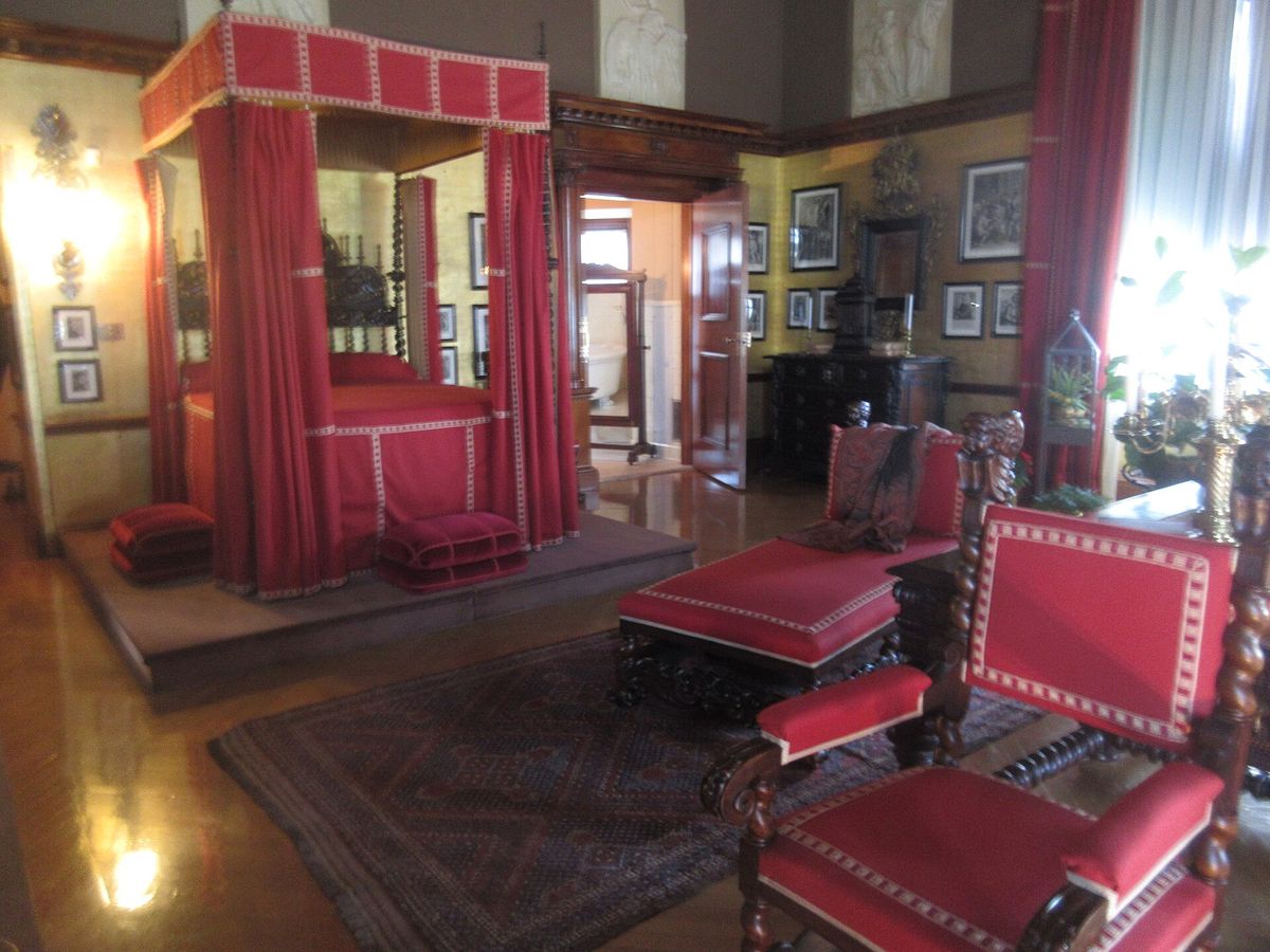 Grand master bedroom with a red four-poster bed at the Biltmore Estate