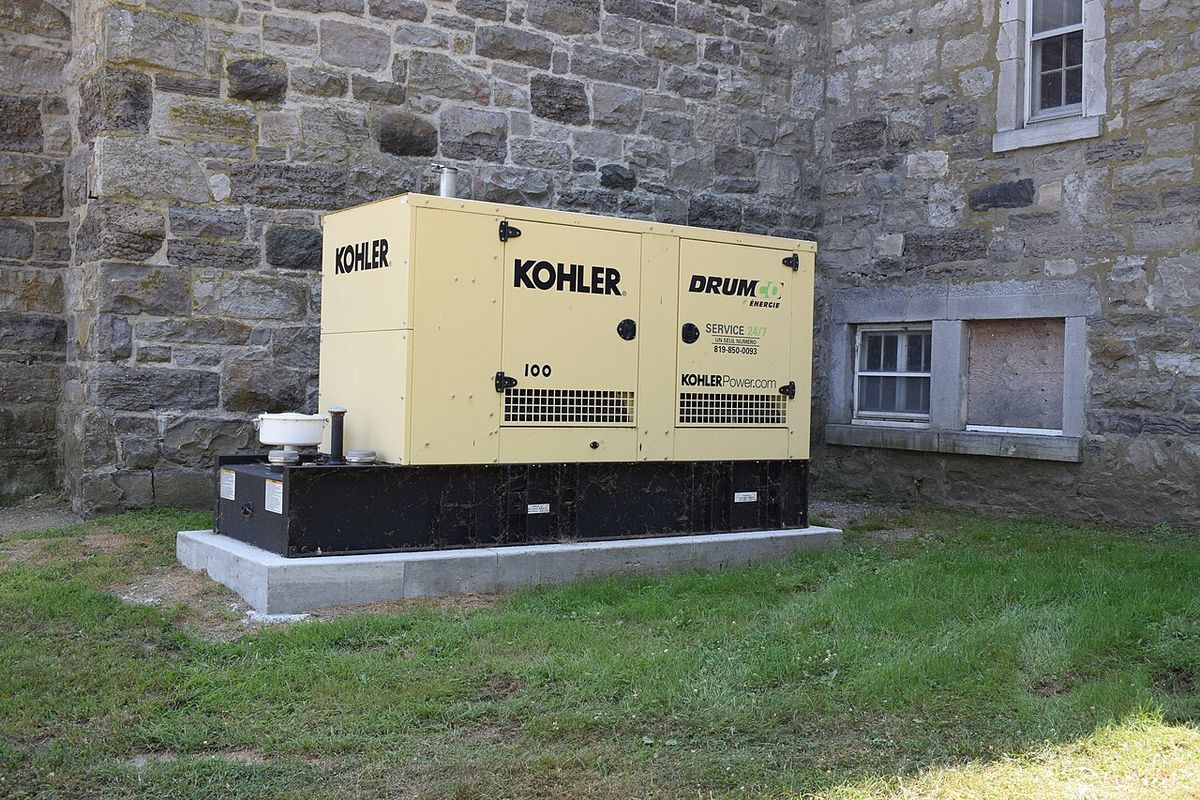 Kohler standby generator unit installed on a concrete pad