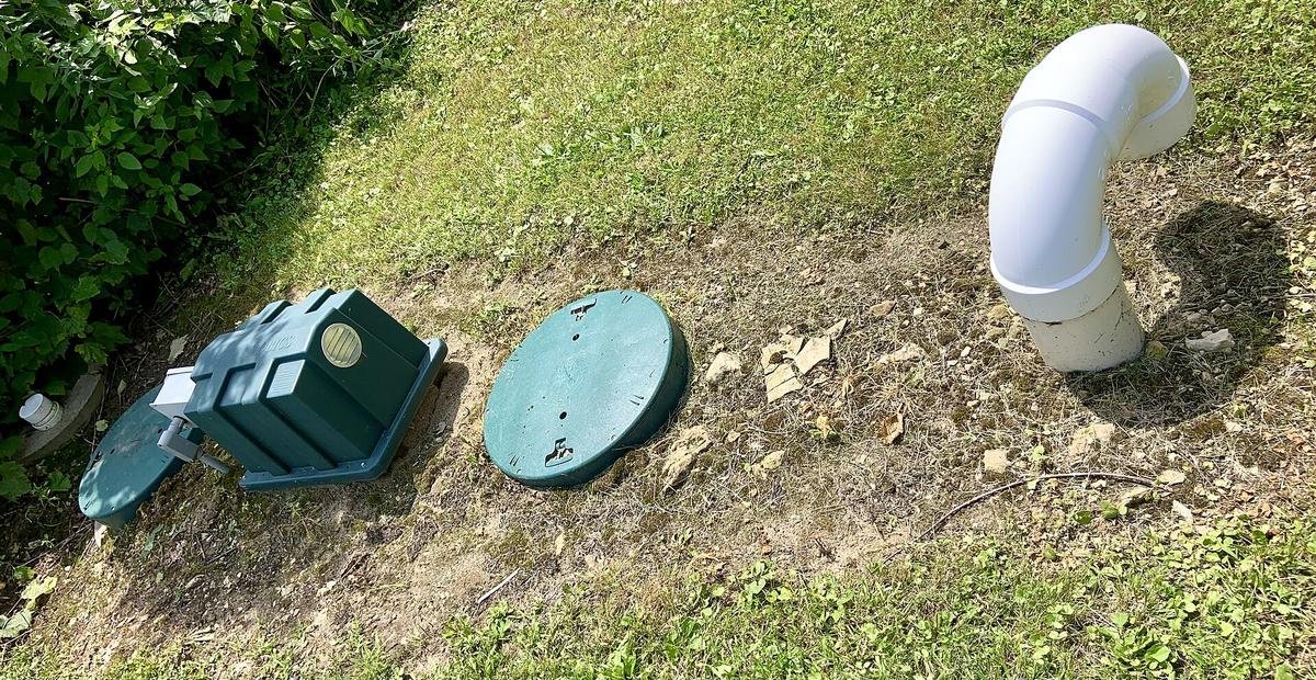 Septic tank access risers and vent pipe in a home's yard