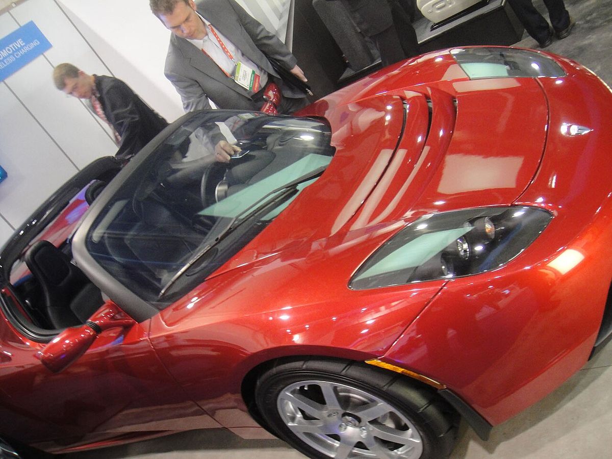 Tesla electric car on a wireless charging demonstration pad at CES 2012